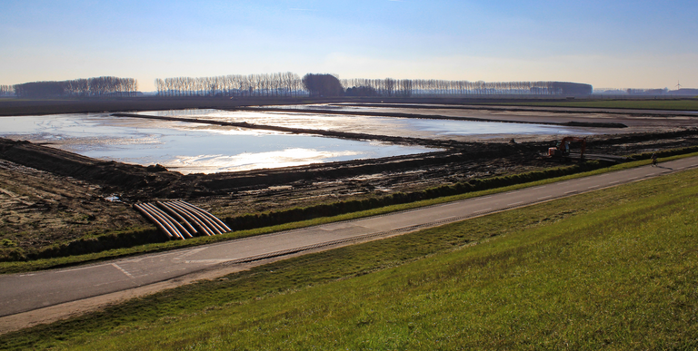 Image of two sludge drying bed, showing drainage pipes and access road