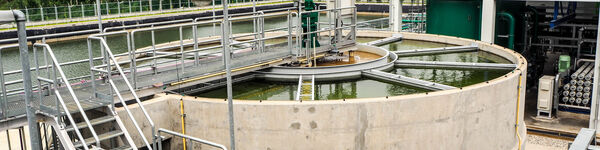 Sludge  cylindrical sedimentation tank with a galvanised metal platform and railings above it