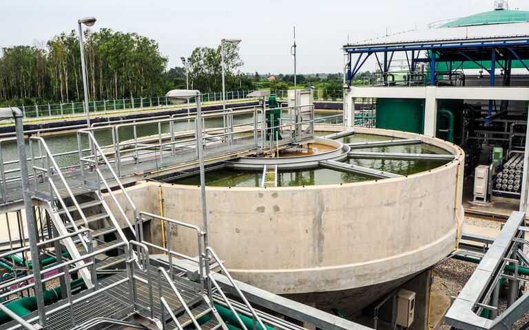 Sludge  cylindrical sedimentation tank with a galvanised metal platform and railings above it