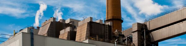 Waste incinerator against a blue sky with clouds