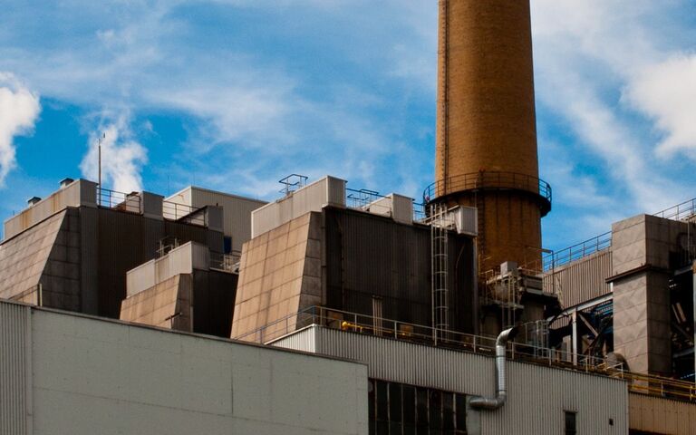 Waste incinerator against a blue sky with clouds